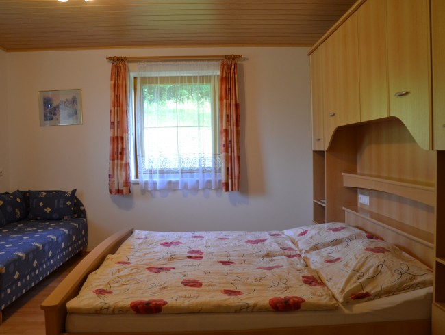 Schlafzimmer mit Doppelbett und Ausziehcouch